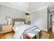This bedroom features a chandelier, a woven rug, and large windows at 1635 Bull Creek Ln, Charleston, SC 29414