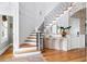 Elegant foyer with hardwood floors, a staircase, and a stylish console table creating an inviting entrance at 1635 Bull Creek Ln, Charleston, SC 29414