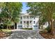 Stately two-story home with a grand entrance, blue shutters, and mature trees shading the property at 1635 Bull Creek Ln, Charleston, SC 29414