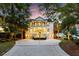 Elegant multi-story home with a wide driveway, manicured landscaping, and a charming front porch at 1635 Bull Creek Ln, Charleston, SC 29414