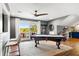 Bright game room with a pool table, bar area, and large sliding glass doors to a balcony overlooking the beautiful outdoors at 1635 Bull Creek Ln, Charleston, SC 29414