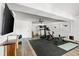 Bright home gym featuring workout equipment, rubber floor, flatscreen TV, and white walls at 1635 Bull Creek Ln, Charleston, SC 29414