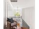 Elegant hallway features wood floors, paneled walls, staircase, and natural light from the window at 1635 Bull Creek Ln, Charleston, SC 29414