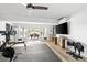 Spacious home gym featuring various exercise equipment, a mounted TV, and access to an outdoor patio at 1635 Bull Creek Ln, Charleston, SC 29414