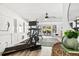 Well-lit home gym with treadmill, stationary bike, and view to outdoor seating at 1635 Bull Creek Ln, Charleston, SC 29414