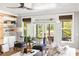 Bright living room with ceiling fan, shelving, white trim and doors to covered patio at 1635 Bull Creek Ln, Charleston, SC 29414