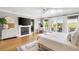 Bright bedroom featuring wood floors, fireplace, private balcony, and an ensuite bathroom at 1635 Bull Creek Ln, Charleston, SC 29414