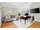 Stylish office with hardwood floors, a sleek desk, a comfortable sofa, and a view of the outdoors at 1635 Bull Creek Ln, Charleston, SC 29414