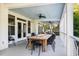Spacious, covered outdoor patio with fire feature on dining table at 1635 Bull Creek Ln, Charleston, SC 29414