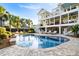 Inviting pool area with lounge chairs, lush landscaping, and multi-story house in the background at 1635 Bull Creek Ln, Charleston, SC 29414