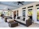 Inviting covered porch featuring comfortable seating, ceiling fans, and views of the surrounding landscape at 1635 Bull Creek Ln, Charleston, SC 29414