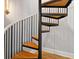 This staircase features wood treads, black metal balusters, and white curved wall at 1635 Bull Creek Ln, Charleston, SC 29414