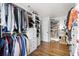 Spacious walk-in closet with custom shelving, drawers, and hardwood floors, offering organized storage at 1635 Bull Creek Ln, Charleston, SC 29414