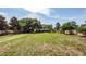 Large grassy backyard with mature trees and wooden fence, offering plenty of space for recreation and relaxation at 1648 Secessionville Rd, Charleston, SC 29412