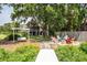 Relaxing backyard featuring an outdoor swing, fire pit with Adirondack chairs, and a beautiful pier at 1648 Secessionville Rd, Charleston, SC 29412