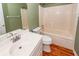 Full bathroom with white vanity, toilet, and a tiled bathtub with shower combination at 1648 Secessionville Rd, Charleston, SC 29412