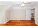 Well-lit bedroom featuring hardwood floors, a ceiling fan, and access to an upstairs hallway at 1648 Secessionville Rd, Charleston, SC 29412