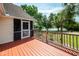 Wooden deck overlooking a picturesque backyard with lush greenery and a glimpse of the water at 1648 Secessionville Rd, Charleston, SC 29412