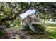Stunning elevated home with a charming porch, lush landscaping, and a driveway leading to the property at 1648 Secessionville Rd, Charleston, SC 29412