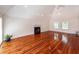 Open living room with a fireplace, glossy hardwood floors, and bright natural light at 1648 Secessionville Rd, Charleston, SC 29412