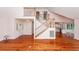Bright living room featuring hardwood floors, staircase, and ample natural light at 1648 Secessionville Rd, Charleston, SC 29412