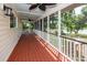 Relaxing screened porch with lake views, ceiling fans, and wood floors at 1648 Secessionville Rd, Charleston, SC 29412
