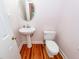 Charming powder room featuring a pedestal sink, toilet, and classic fixtures at 1648 Secessionville Rd, Charleston, SC 29412