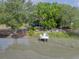 Picturesque waterfront view with private dock, bench swing and outdoor furniture at 1648 Secessionville Rd, Charleston, SC 29412