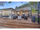 Spacious back deck area featuring ample seating, a fire pit, string lights and shade, ideal for relaxation and gatherings at 1673 Mcclain St, Charleston, SC 29407