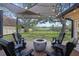Scenic backyard deck with a fire pit, chairs, and a shady canopy, perfect for enjoying outdoor living and tranquil scenery at 1673 Mcclain St, Charleston, SC 29407