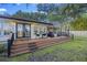 Inviting back deck with wooden steps and outdoor seating, perfect for entertaining and enjoying the backyard view at 1673 Mcclain St, Charleston, SC 29407