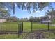 Expansive fenced backyard with gate, lush lawn, and serene views of the canal at 1673 Mcclain St, Charleston, SC 29407