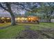 Inviting backyard deck with outdoor seating, string lights, and a view of the lush green lawn at 1673 Mcclain St, Charleston, SC 29407