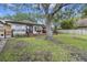 Charming backyard with a spacious deck, mature tree and a wrought iron fence at 1673 Mcclain St, Charleston, SC 29407