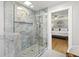 Bathroom featuring marble shower, glass door, and view into the main bedroom at 1673 Mcclain St, Charleston, SC 29407