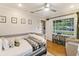 Bright bedroom featuring a bed, sitting chair, and a large window at 1673 Mcclain St, Charleston, SC 29407