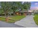 Charming single-story brick home featuring a covered carport and a lush front yard with mature trees at 1673 Mcclain St, Charleston, SC 29407