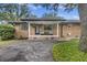 Inviting brick home with a cozy front porch and well-manicured landscaping at 1673 Mcclain St, Charleston, SC 29407