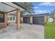 Modern two-car garage with stylish black doors and manicured landscaping at 1673 Mcclain St, Charleston, SC 29407