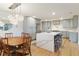 Bright, open kitchen featuring modern cabinets, a large island, stainless steel appliances, and wood flooring at 1673 Mcclain St, Charleston, SC 29407