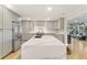 A beautifully designed kitchen features stainless steel appliances, quartz countertops, and grey cabinets at 1673 Mcclain St, Charleston, SC 29407