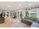 Bright and airy living room with hardwood floors, a comfortable couch, and abundant natural light at 1673 Mcclain St, Charleston, SC 29407