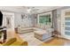 A well-lit living room with a large window, comfortable sectional sofa, and stylish decor at 1673 Mcclain St, Charleston, SC 29407