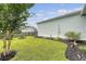 View of a green backyard with black mulch and privacy fence at 1822 Grovehurst Dr, Charleston, SC 29414