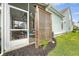 View of the fenced-in backyard with a screen porch and privacy lattice at 1822 Grovehurst Dr, Charleston, SC 29414