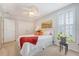 Bright bedroom features a bed with decorative pillows, ceiling fan, and shuttered windows at 1822 Grovehurst Dr, Charleston, SC 29414