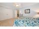Bright bedroom boasts a ceiling fan, double closet, and doorway with vintage-style decor at 1822 Grovehurst Dr, Charleston, SC 29414