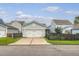 Garage with driveway, light-green house, front lawn, and black fence at 1822 Grovehurst Dr, Charleston, SC 29414