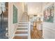 Bright foyer with wood staircase, seamlessly flowing into an open-concept living space at 1822 Grovehurst Dr, Charleston, SC 29414