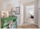 Hallway featuring a vintage green vanity and blue velvet chair, plus view into a bedroom at 1822 Grovehurst Dr, Charleston, SC 29414